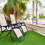 Two,Empty,Lounge,Chairs,On,Artificial,Lawn,Grass,Inside,Of