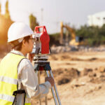 Surveyor engineer is measuring level on construction site. Surve